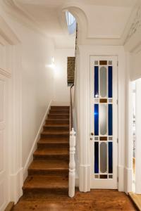 a staircase in a home with white walls and a door at naBaixa Apartments in Porto