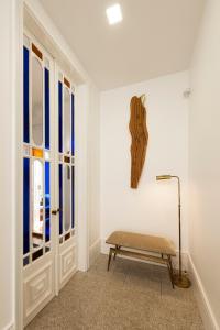 a room with a bench and a window at naBaixa Apartments in Porto
