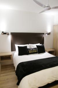 a bedroom with a large bed with a black headboard at 205 New Cumberland in Cape Town