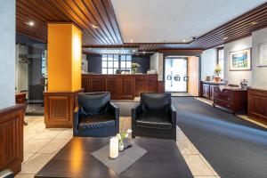 a waiting room with two chairs and a table at HotelChur.ch in Chur