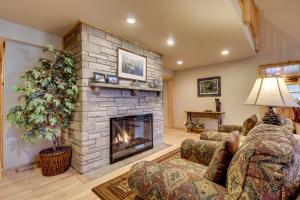 a living room with a large stone fireplace at Island View I in Eagle River