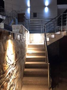 a set of stairs in a building with lights at Thealos Rooms in Vourvourou