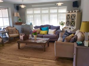 a living room with a couch and a table at The Beach House in West Wittering
