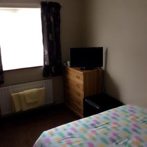 A television and/or entertainment center at The Lodge Guest House 