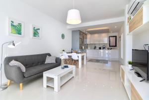 a living room with a couch and a table at Playa Elisa Bay - Mil Palmeras in Pilar de la Horadada