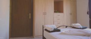 a bedroom with a bed and a dresser and a closet at Villa Platanaki in Kerveli
