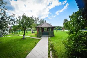 a gazebo in the middle of a green field at Villa Bravo Breaza in Breaza