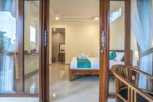 Postel nebo postele na pokoji v ubytování Darba Guest House Ubud