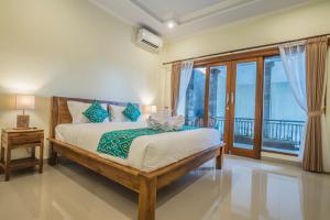 Postel nebo postele na pokoji v ubytování Darba Guest House Ubud