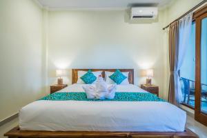 Postel nebo postele na pokoji v ubytování Darba Guest House Ubud