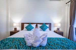 Postel nebo postele na pokoji v ubytování Darba Guest House Ubud