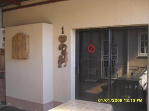 a front door of a house with teddy bears on the wall at Silvermoon in Nigel