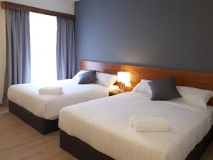 Ένα ή περισσότερα κρεβάτια σε δωμάτιο στο Hotin Inn