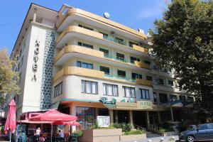 a large building with a restaurant in front of it at Hotel Trakia in Pazardzhik