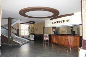 a lobby with a staircase and a sign that reads reception at Hotel Trakia in Pazardzhik