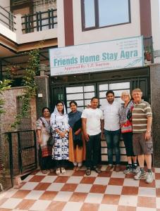 a group of people standing in front of a building at Friends Home Stay - Agra in Agra