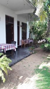 a patio with a table and chairs on a house at Serene Niche in Mirissa