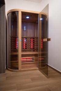 a glass door in a room with a wine cellar at Nature View House with Sauna in Tolmin