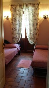 a room with two beds and a window at Alloggi Agrituristici Antica Dimora in San Demetrio neʼ Vestini