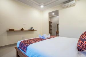 Postel nebo postele na pokoji v ubytování Darba Guest House Ubud