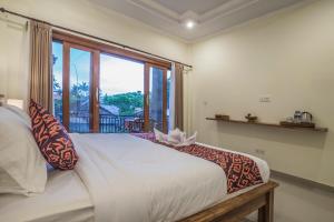 Postel nebo postele na pokoji v ubytování Darba Guest House Ubud