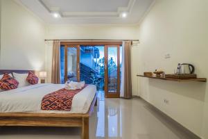 Postel nebo postele na pokoji v ubytování Darba Guest House Ubud