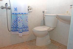 a bathroom with a toilet and a sink and a shower at Hotel Trakia in Pazardzhik +14 photos