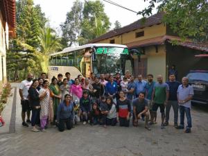 a group of people standing in front of a bus at Hiliya Resort in Kenichira