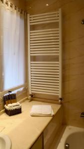 a bathroom with a sink and a tub and a window at A Casa di Grace in Basiglio