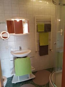 a bathroom with a sink and a shower with towels at Lukas Oscar in Bad Blumau