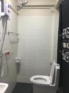 a bathroom with a toilet and a sink at Maerim Hostel in Chiang Mai