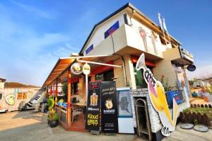 a building with a surfboard on the front of it at Jarasum Guest House in Gapyeong