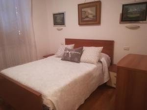 a bedroom with a bed with two pillows on it at B&B A Ridosso in Gubbio