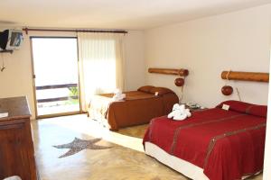 a hotel room with two beds and a window at Blue Angel Resort in Cozumel +19 photos
