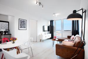 a living room with a couch and a table at Apartament Wyzwolenia - Unique Apartments in Szczecin