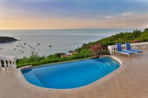 a swimming pool with a view of the ocean at The Lighthouse Ocotal in Coco