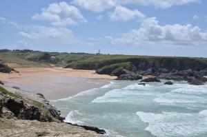 a beach with waves crashing on the shore at Hotel Atlantique in Le Palais