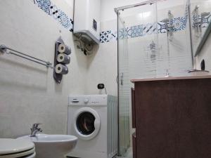 a bathroom with a washing machine and a sink at Domus Venere in Pompei +41 photos