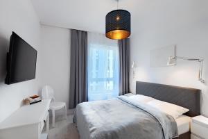 Ein Bett oder Betten in einem Zimmer der Unterkunft Apartament Dembowskiego - Unique Apartments