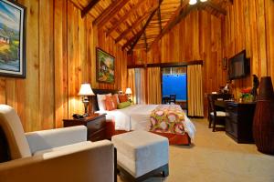Cama o camas de una habitación en Hotel Lomas del Volcan