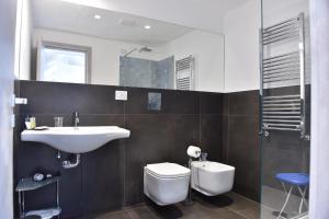a bathroom with a sink and a toilet at Specchio di Parthenope B&B in Naples