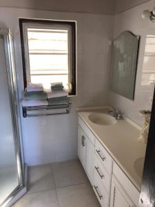 a bathroom with a sink and a window and towels at Trilogy Villas in English Harbour Town +19 photos