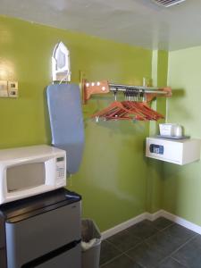 a kitchen with a microwave on top of a refrigerator at Seahawk Motel in Virginia Beach