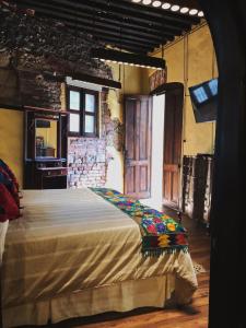 a bedroom with a large bed in a room at Hotel Boutique Los Camilos in Mexico City