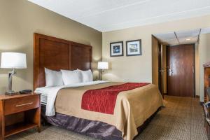 a hotel room with a large bed and a table at Comfort Inn Cranberry Twp in Cranberry Township