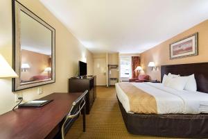 a hotel room with a bed and a desk at McIntosh Inn in Media