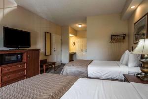a hotel room with two beds and a television at Quality Inn Kingsport in Kingsport