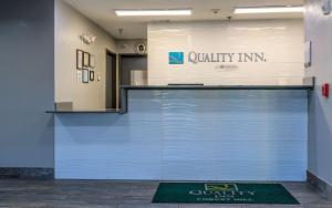 a blue garage door with a sign on a wall at Quality Inn in Forest Hill