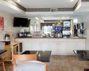 a large kitchen with white cabinets and a counter at Econo Lodge Hopewell Near Fort Lee I-295 in Hopewell