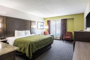 a hotel room with a large bed and a window at Quality Inn Warsaw near Rappahannock River in Warsaw